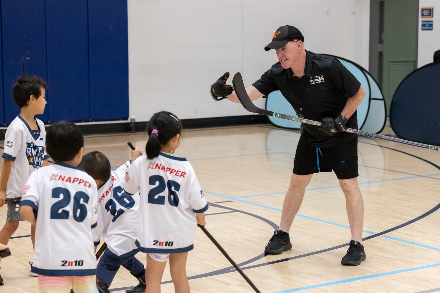 Coach Salvatore coaching a small group of young ECBH players