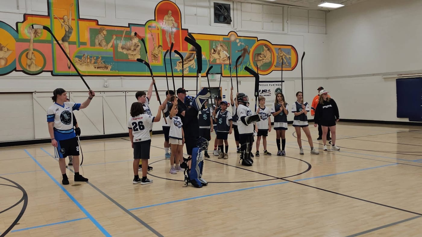 Players raising sticks together at ECBH