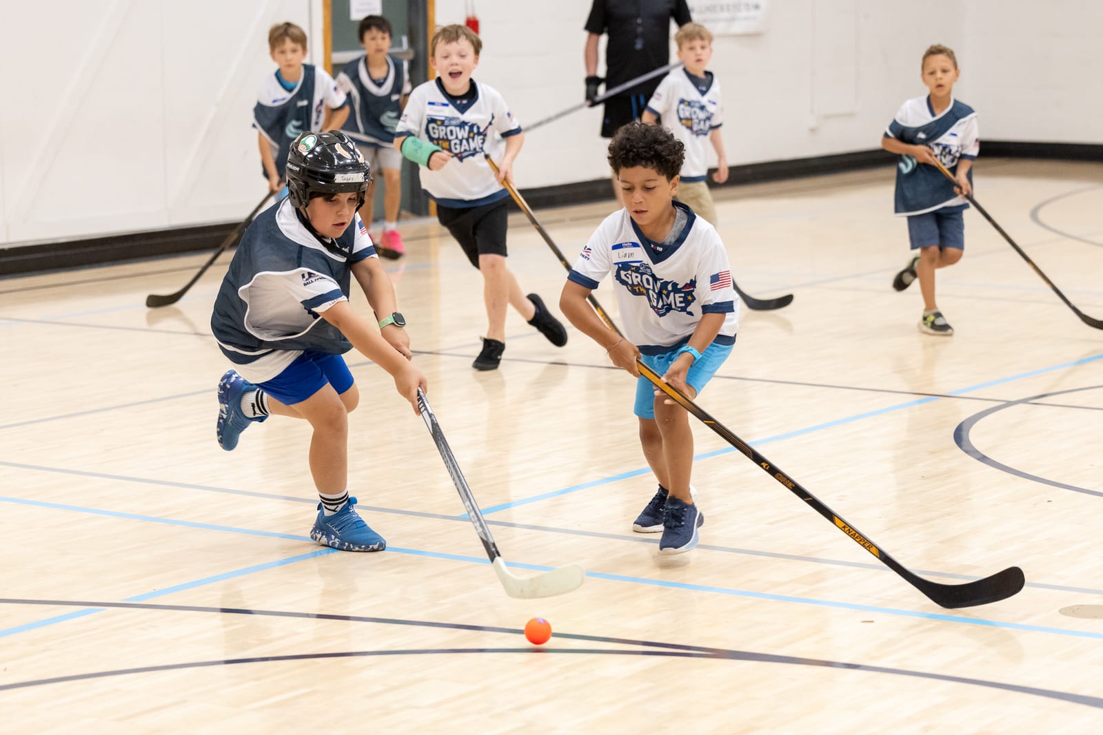 Young players battling for the ball during an Emerald City Ball Hockey game