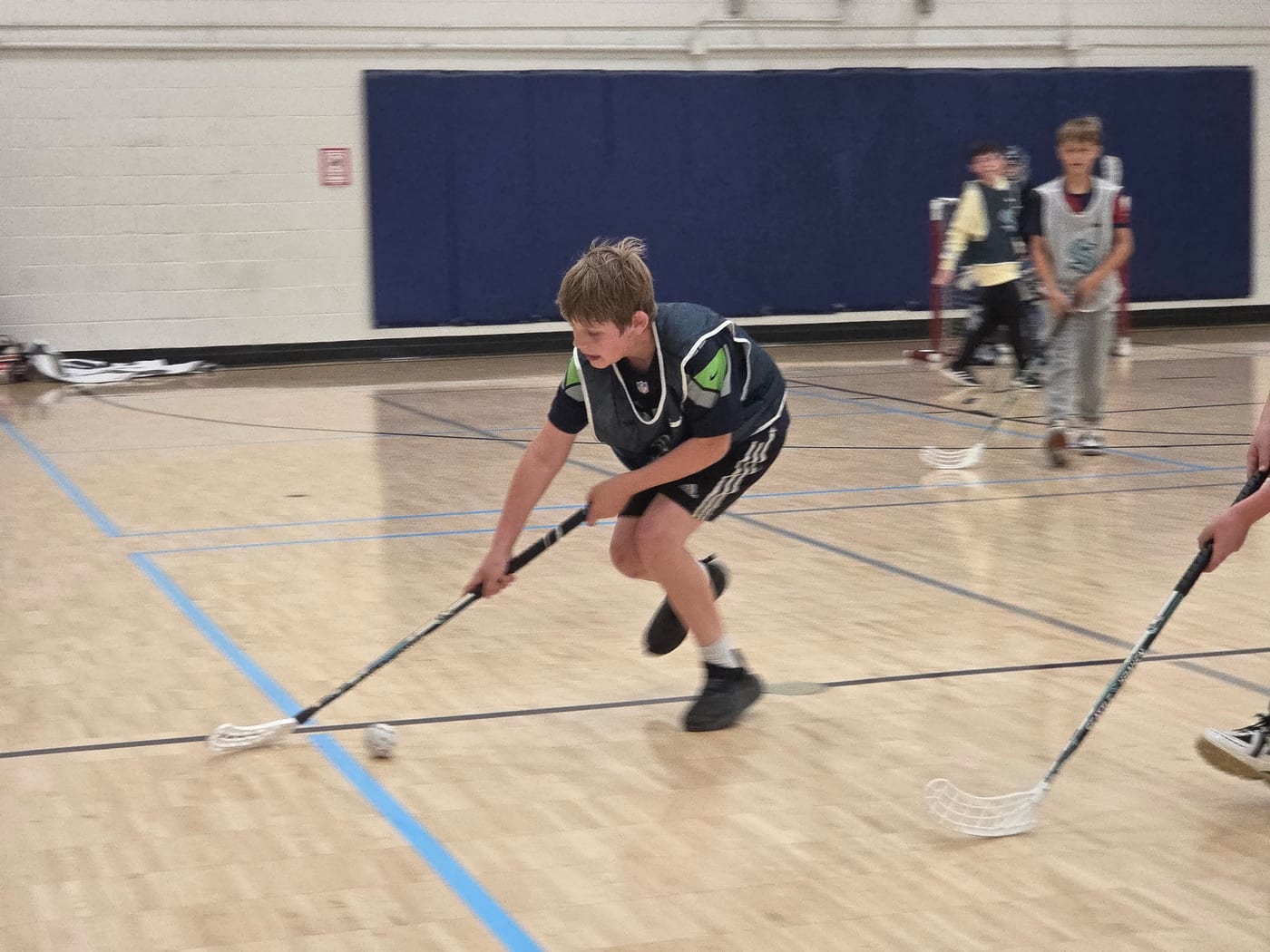 An older Emerald City player driving up the floor with the ball