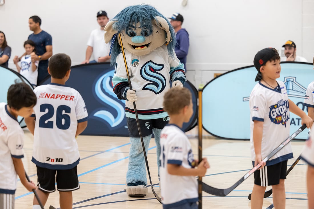 Buoy, the Seattle Kraken mascot, plays ball hockey with the kids