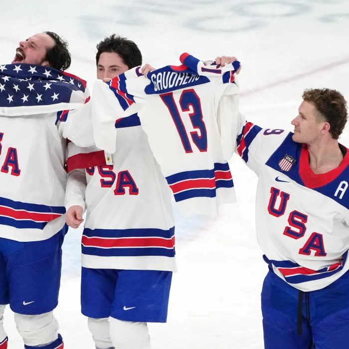 USA Men's hockey team holds up Gaudreau jersey